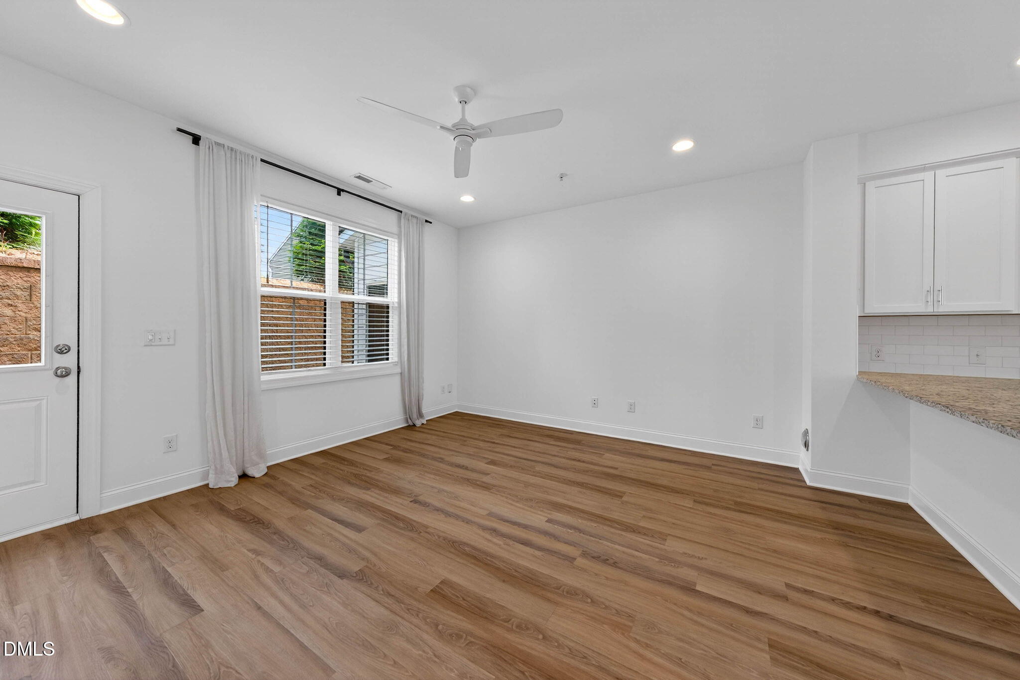 6820 Milligan Way, Unit 104 Raleigh, NC 27613 - Photo 20 of 39 a view of empty room with wooden floor and fan