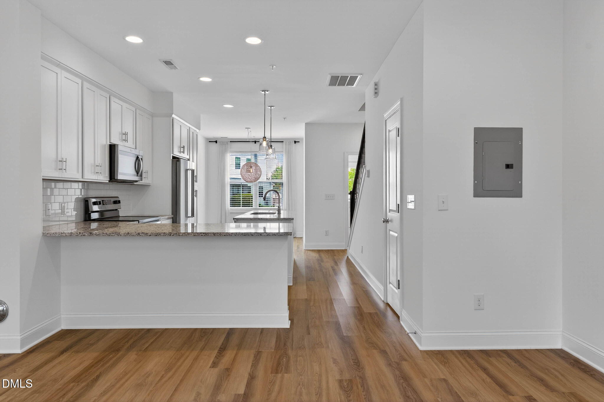 6820 Milligan Way, Unit 104 Raleigh, NC 27613 - Photo 22 of 39 a view of a kitchen with wooden floor and electronic appliances