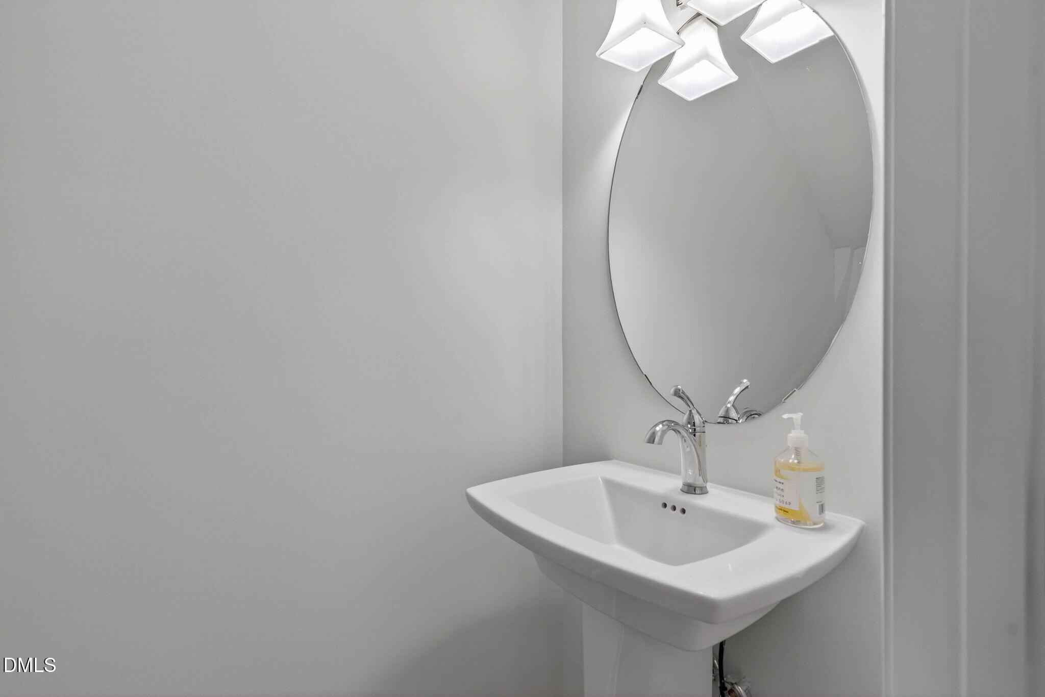 6820 Milligan Way, Unit 104 Raleigh, NC 27613 - Photo 23 of 39 a bathroom with a sink and a mirror