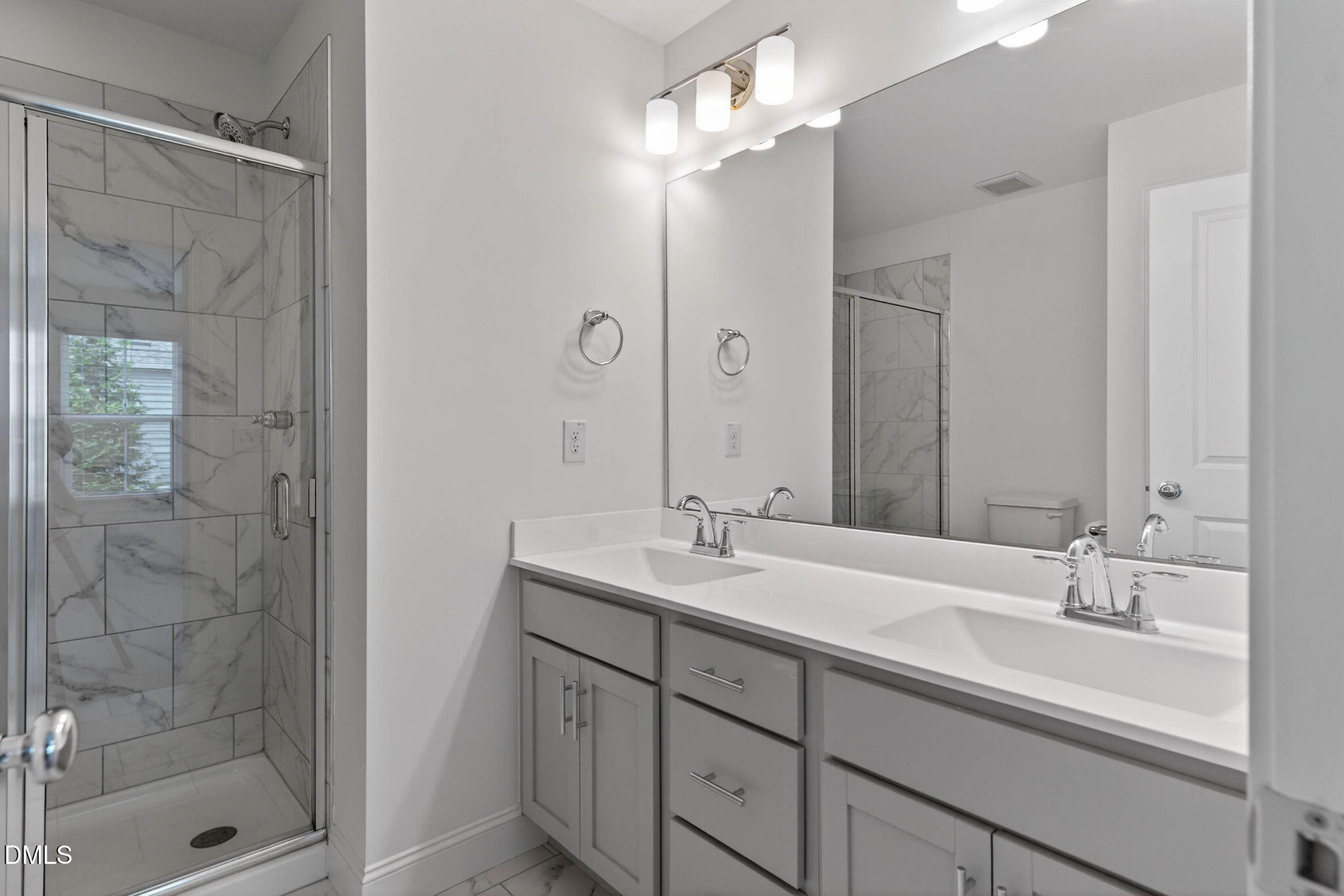 6820 Milligan Way, Unit 104 Raleigh, NC 27613 - Photo 26 of 39 a bathroom with a double vanity sink mirror and shower
