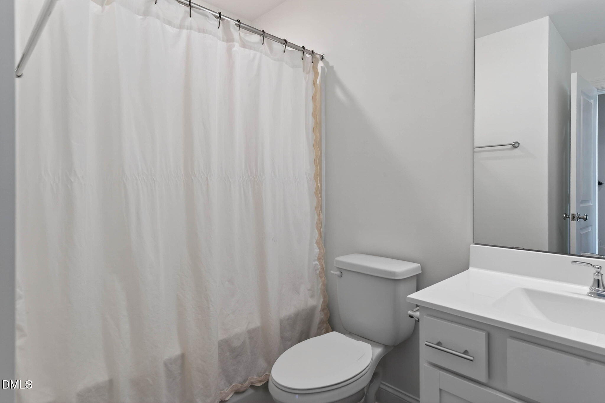 6820 Milligan Way, Unit 104 Raleigh, NC 27613 - Photo 29 of 39 a bathroom with a toilet a sink and curtain