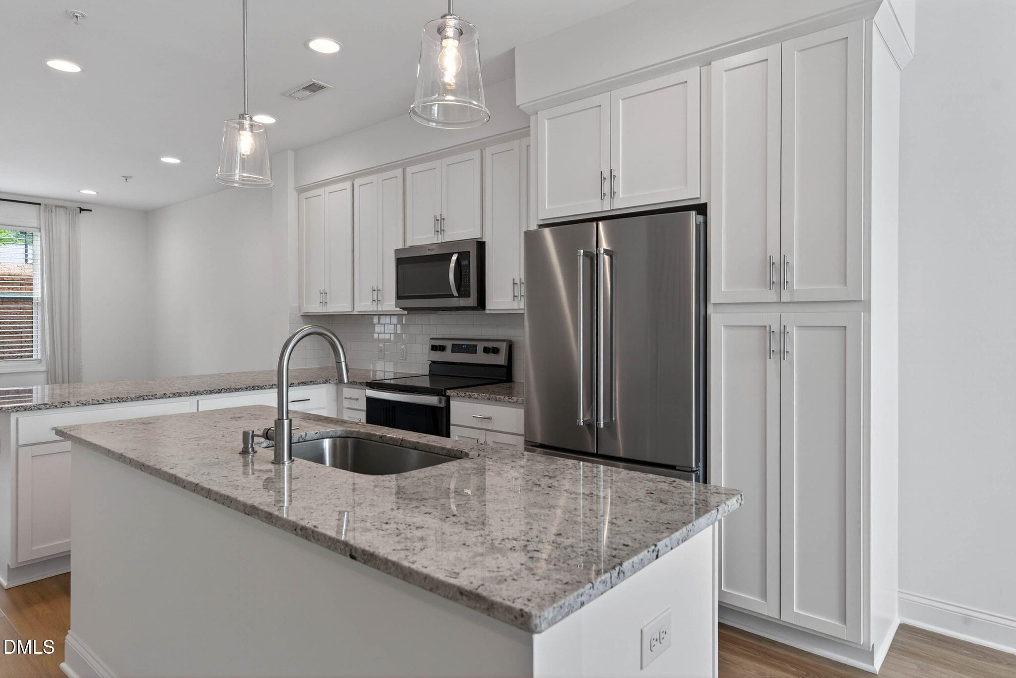 6820 Milligan Way, Unit 104 Raleigh, NC 27613 - Photo 7 of 39 a kitchen with stainless steel appliances granite countertop a sink a refrigerator and a granite counter tops