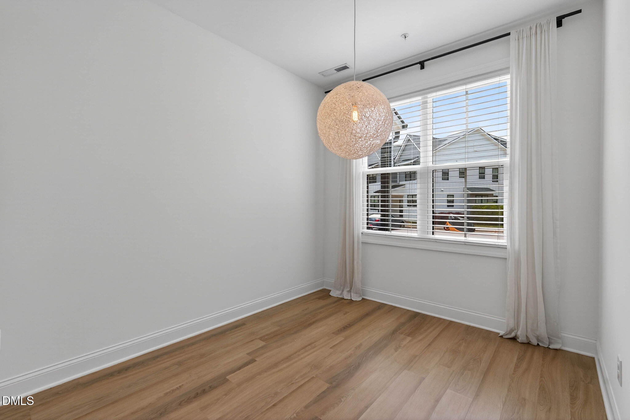 6820 Milligan Way, Unit 104 Raleigh, NC 27613 - Photo 8 of 39 a view of a room with wooden floor and windows