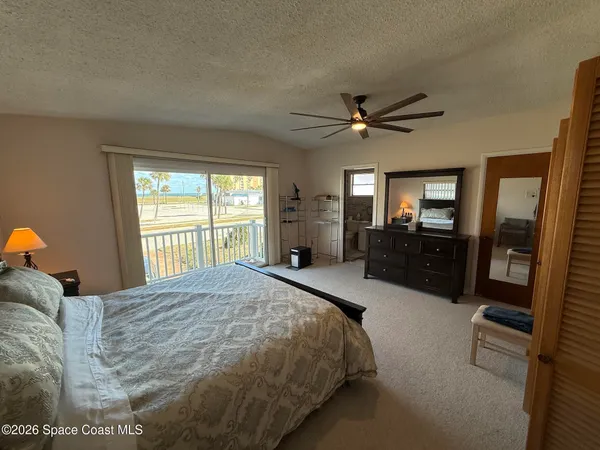 a bed room with a bed and a large window
