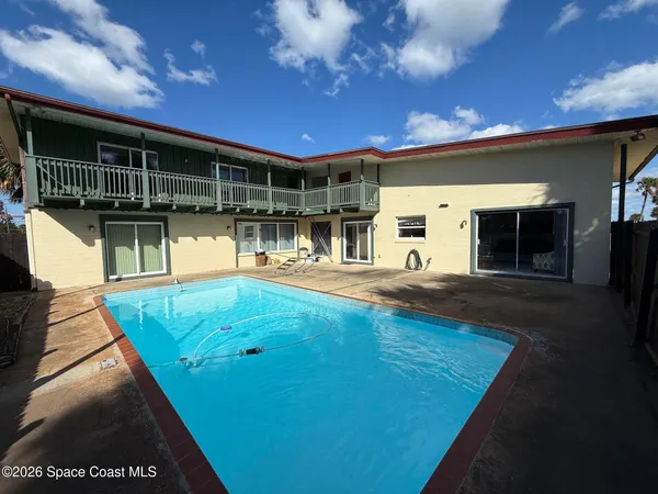 a view of a swimming pool with an outdoor seating