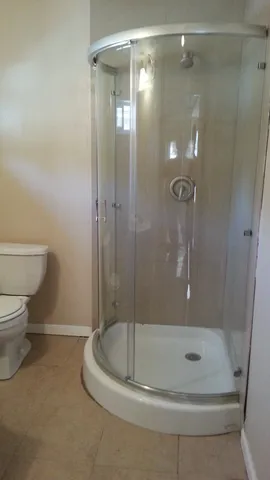 a bathroom with a shower and a toilet