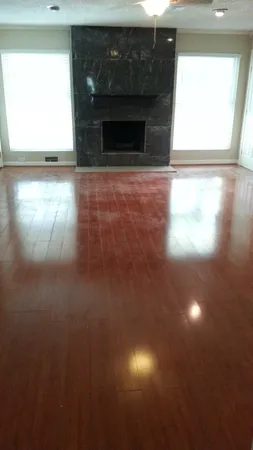 a view of empty room with window and fireplace