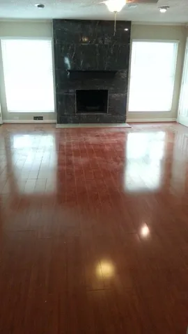a view of empty room with window and fireplace