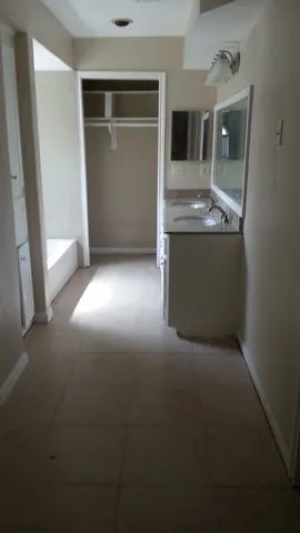 a view of kitchen and hallway with wooden floor