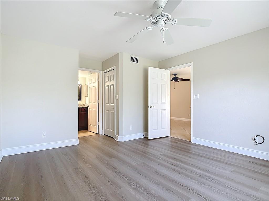 729 Landover Court, Unit 102 Naples, FL 34104 - Photo 11 of 28 a view of an empty room with wooden floor