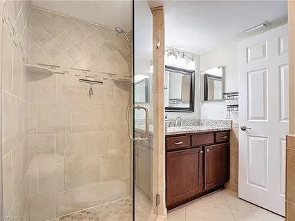 a bathroom with a granite countertop shower mirror and a sink