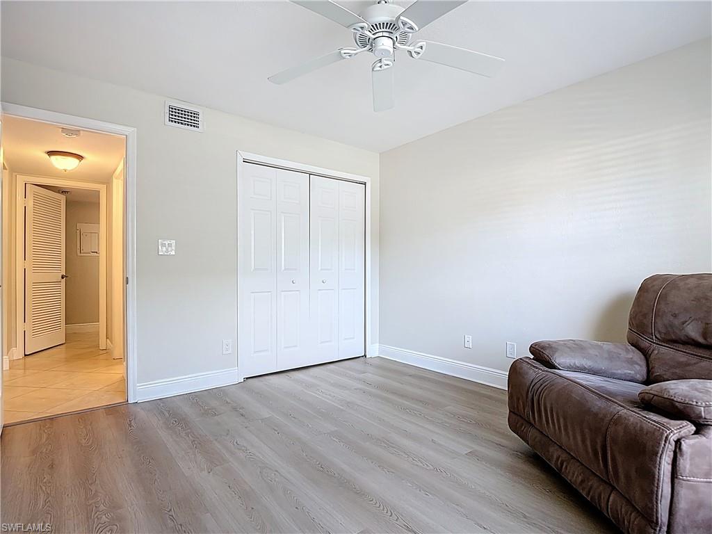 729 Landover Court, Unit 102 Naples, FL 34104 - Photo 14 of 28 a room with furniture and wooden floor