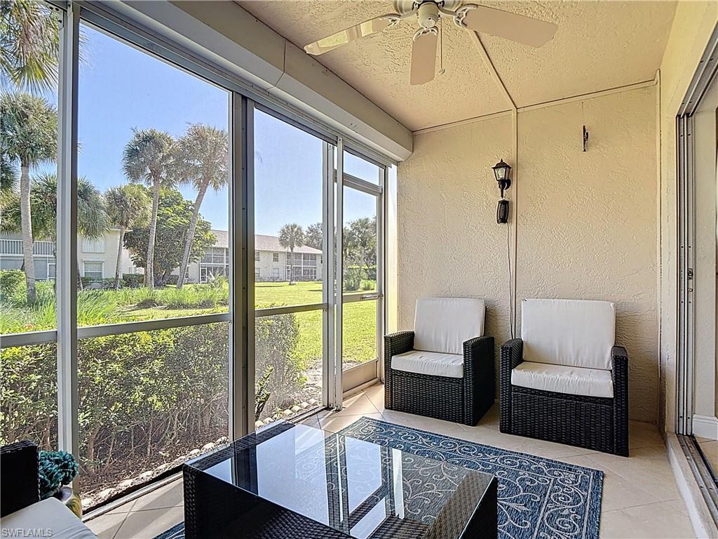 729 Landover Court, Unit 102 Naples, FL 34104 - Photo 20 of 28 a living room with couch and a table