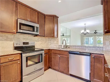a kitchen with granite countertop stainless steel appliances and cabinets