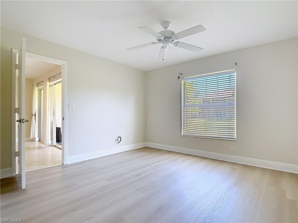 729 Landover Court, Unit 102 Naples, FL 34104 - Photo 10 of 28 a view of an empty room with wooden floor and a window