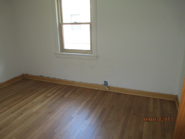 432 Harding Avenue Des Plaines, IL 60016 - Photo 16 of 20 an empty room with wooden floor and windows