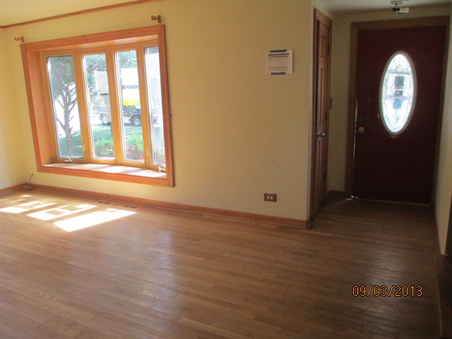 432 Harding Avenue Des Plaines, IL 60016 - Photo 20 of 20 an empty room with wooden floor mirror and windows