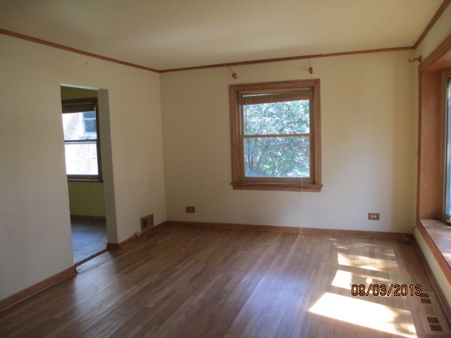 432 Harding Avenue Des Plaines, IL 60016 - Photo 6 of 20 an empty room with wooden floor closet and windows