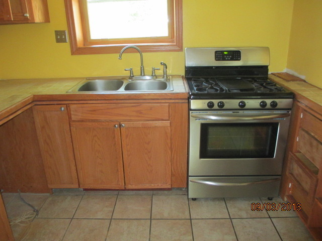 432 Harding Avenue Des Plaines, IL 60016 - Photo 8 of 20 a kitchen with granite countertop a stove top oven and cabinets