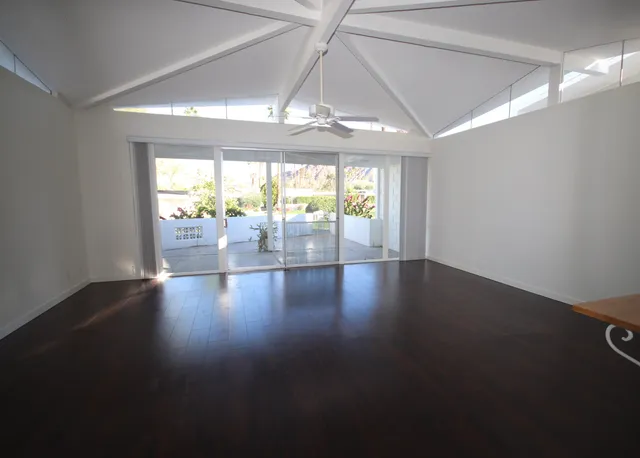 a view of wooden floor and chandelier in a room
