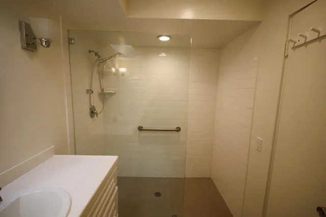 a bathroom with a sink and shower