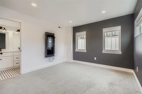 a view of an empty room with a window and fireplace