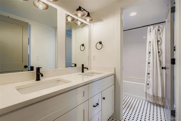 a bathroom with a sink a double vanity and a mirror