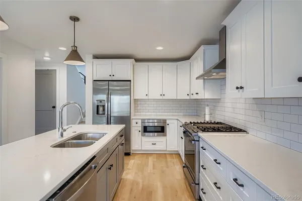a kitchen with a sink stove and refrigerator
