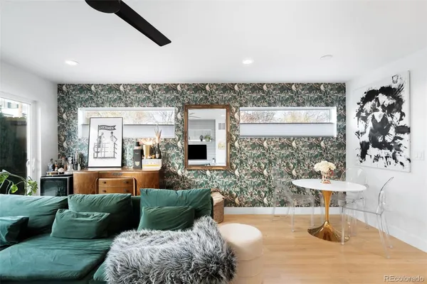 a living room with furniture and a potted plant