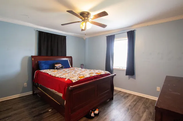 a bedroom with a bed and window