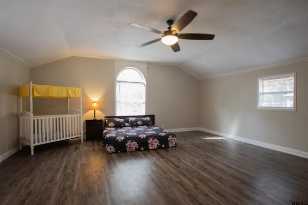 a spacious bedroom with a bed and a window