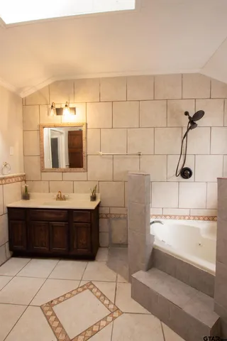 a bathroom with a sink a toilet and mirror