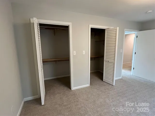 a view of an empty room with a closet
