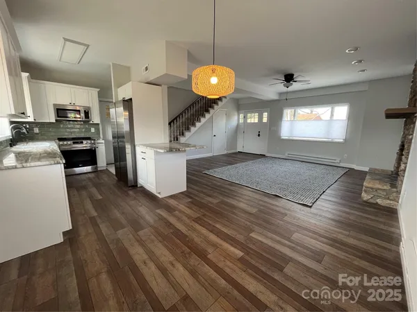 a kitchen with a refrigerator and a stove