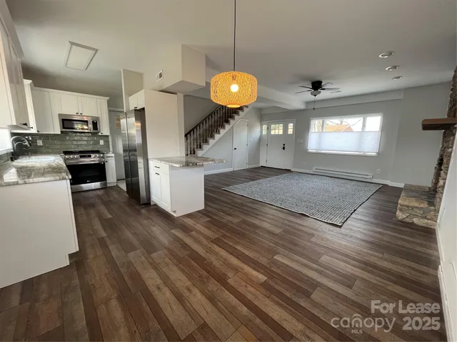 a kitchen with a refrigerator and a stove