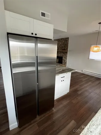 a kitchen with granite countertop a refrigerator and a stove