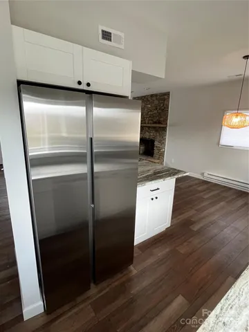 a kitchen with granite countertop a refrigerator and a stove