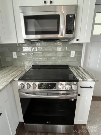 a stove top oven sitting inside of a kitchen