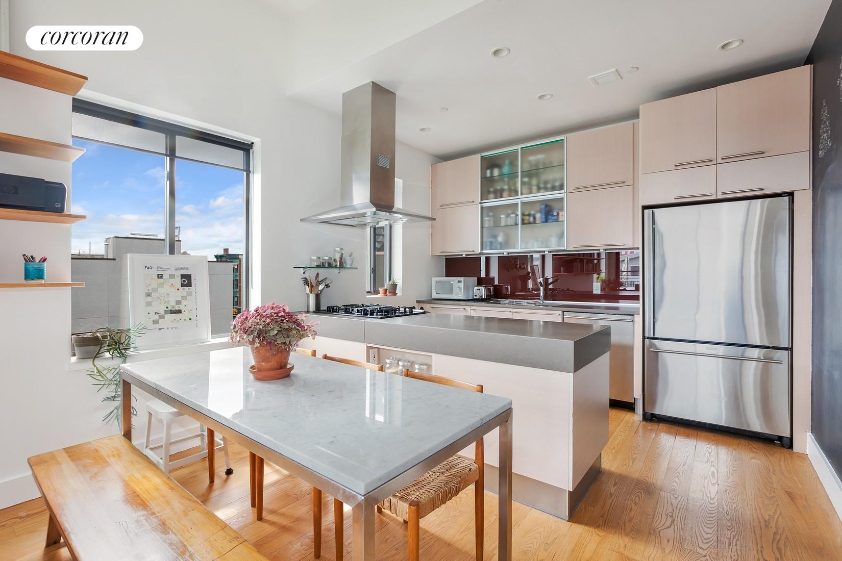 a kitchen with stainless steel appliances granite countertop a sink a stove and a refrigerator