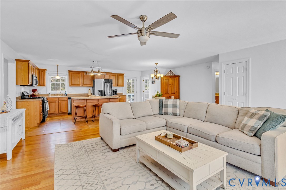43 Ruddy Duck Road Heathsville, VA 22473 - Photo 6 of 46 a living room with furniture kitchen view and a chandelier