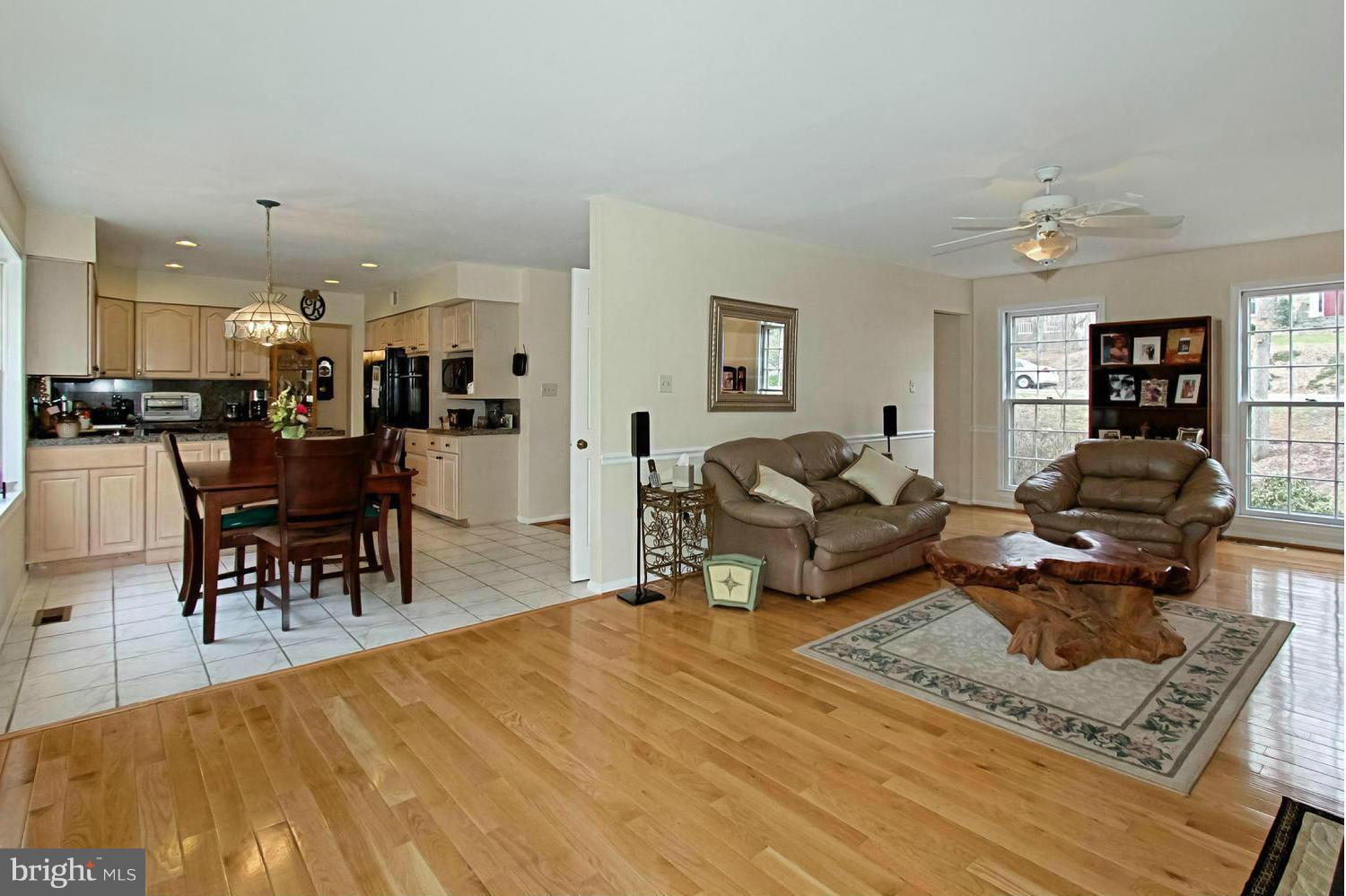 10714 Cross School Road Reston, VA 20191 - Photo 2 of 27 a living room with furniture and a dining table
