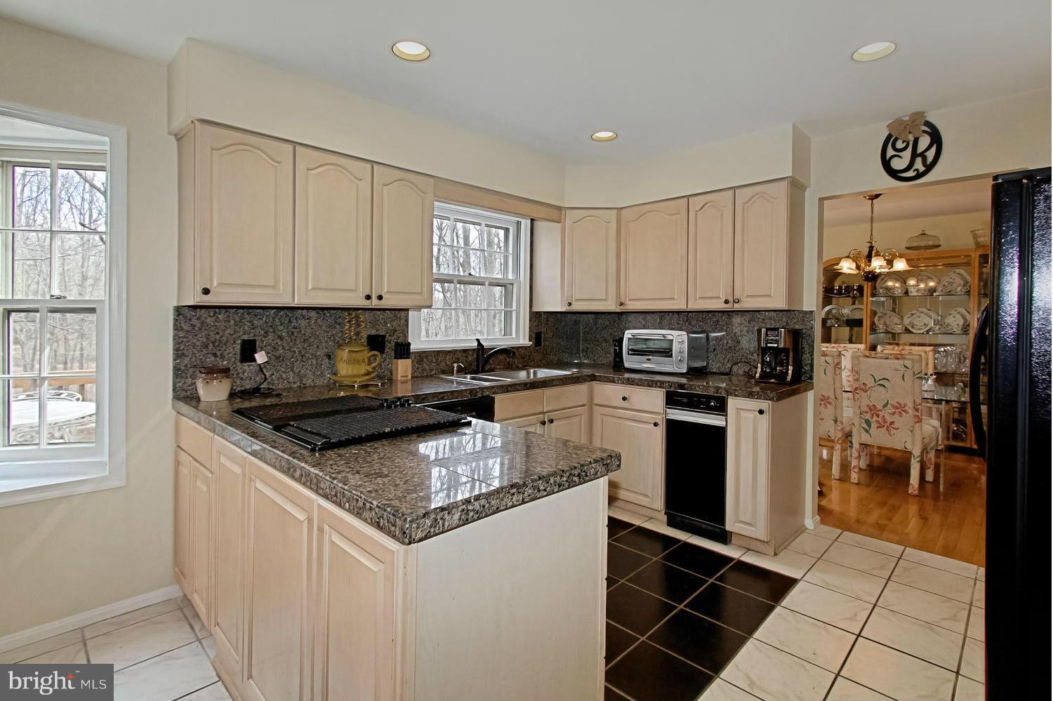 10714 Cross School Road Reston, VA 20191 - Photo 13 of 27 a kitchen with granite countertop a sink stove and refrigerator