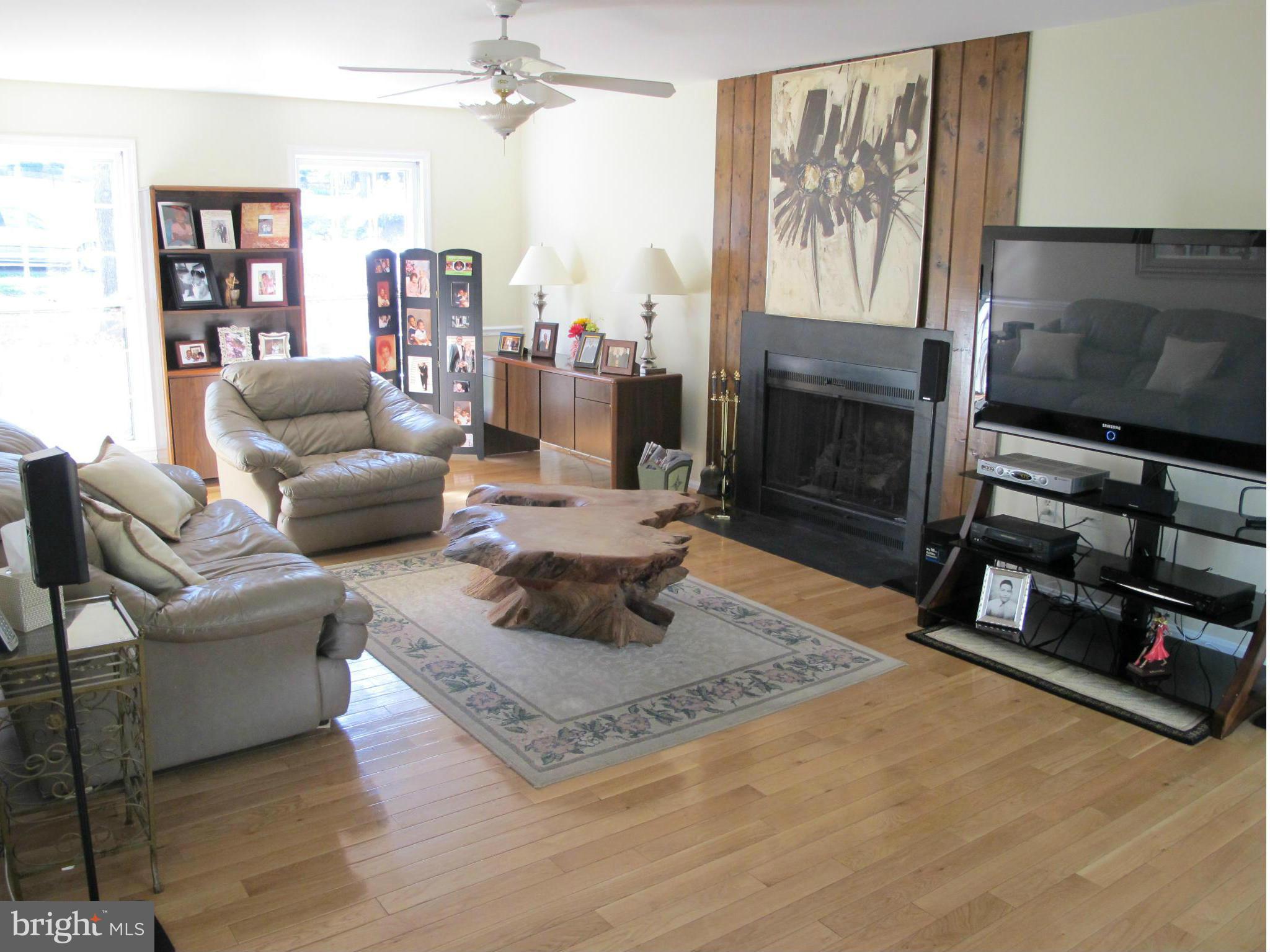 10714 Cross School Road Reston, VA 20191 - Photo 19 of 27 a living room with furniture a flat screen tv and a fireplace