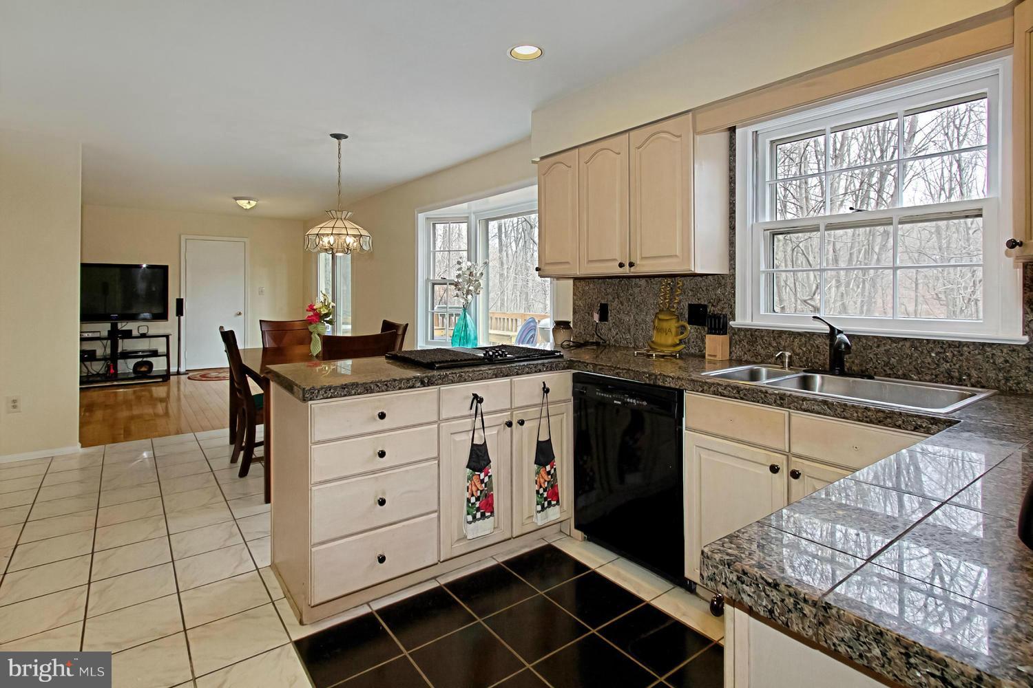 10714 Cross School Road Reston, VA 20191 - Photo 4 of 27 a kitchen with granite countertop a sink stove and cabinets