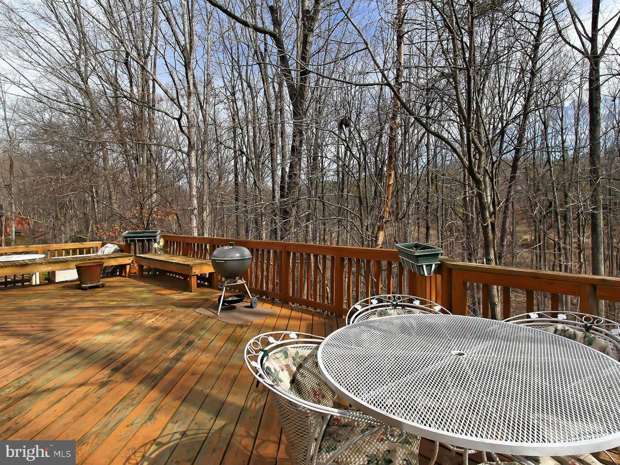 10714 Cross School Road Reston, VA 20191 - Photo 6 of 27 a view of a patio with table and chairs with wooden floor and fence