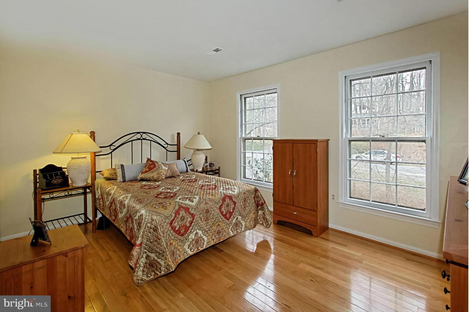 10714 Cross School Road Reston, VA 20191 - Photo 7 of 27 a bedroom with a bed and wooden floor