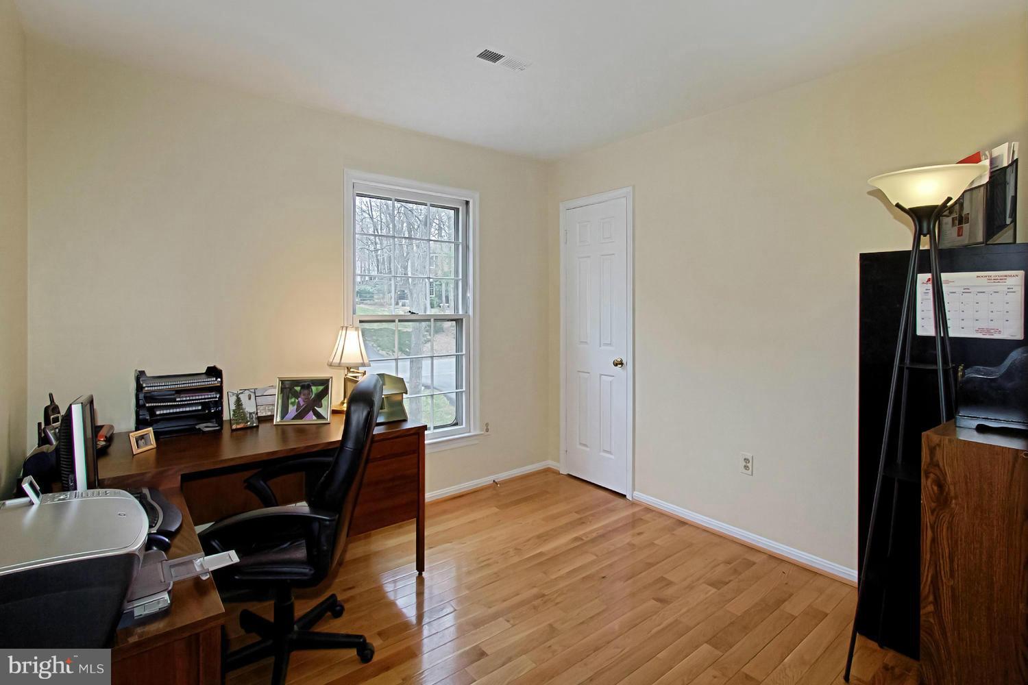 10714 Cross School Road Reston, VA 20191 - Photo 8 of 27 a view of a workspace with furniture and a window