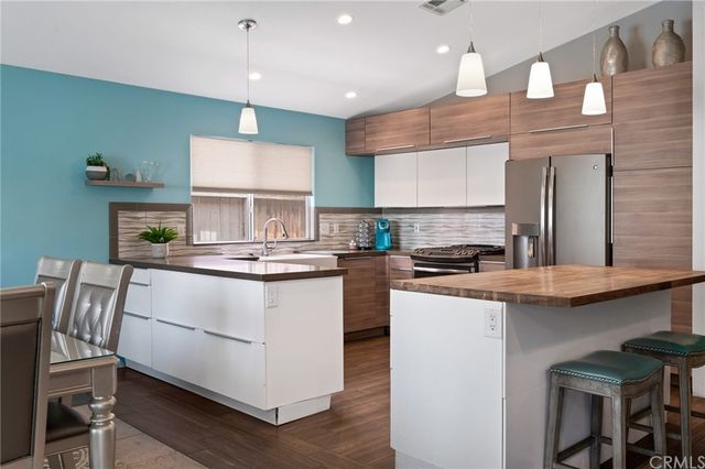 a kitchen with stainless steel appliances granite countertop a white cabinets and stove top oven