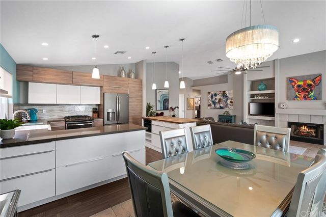a kitchen with stainless steel appliances granite countertop a stove and white cabinets
