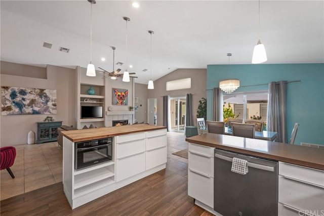 a large white kitchen with a large island in the center